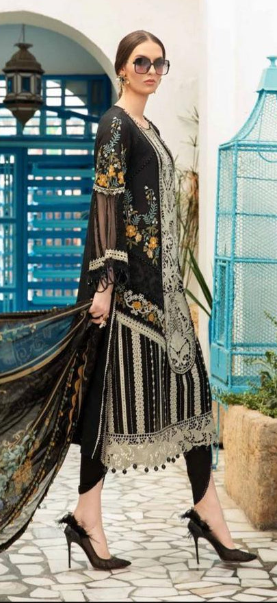 Woman in black and gold traditional outfit with a decorative background